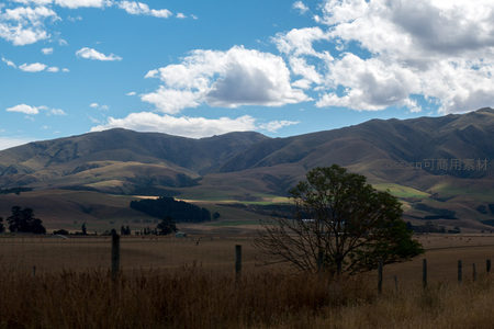 孤树矗立田野前，远山如黛云卷云舒的乡村静景