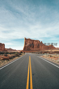 拱门国家公园空旷公路延伸至壮丽红岩巨柱之下