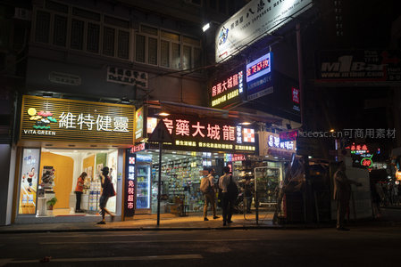 香港夜市街景：维特健灵与药房霓虹灯招牌辉映繁华街道