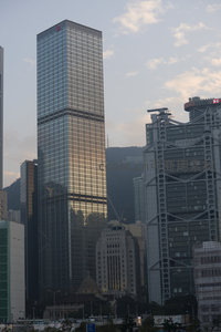 香港国际金融中心大厦玻璃幕墙映照山影与晚霞