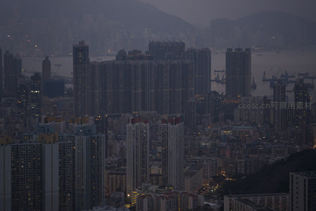 密集公屋群映衬维港夜色，山脚楼宇层层叠叠，展现香港独特居住形态