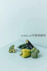浅蓝背景下多彩蔬菜组合静物：西兰花、彩椒、茄子与黄瓜