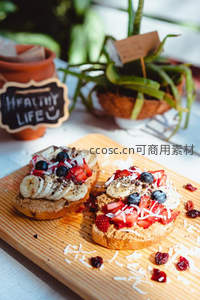 木板上的创意开放式三明治：花生酱基底配水果椰丝装饰