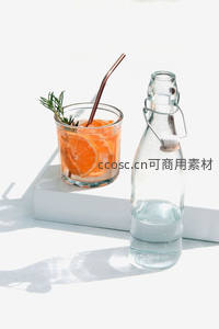 橙片迷迭香冰饮置于白盒旁，铜吸管点缀清新夏日氛围