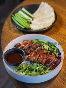 北京烤鸭片配葱丝薄饼，青翠香菜与甜面酱点缀经典中式套餐