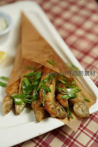 酥脆小鱼干裹葱花盛于牛皮纸锥，复古格纹桌布衬托怀旧风味