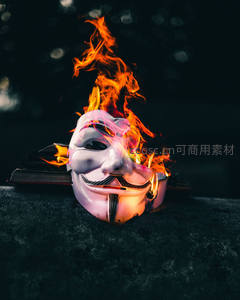 盖伊·福克斯面具在火焰中燃烧，象征意义强烈