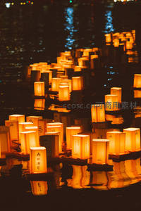 夜色中河面漂浮千盏纸灯，暖光倒影如星河流淌